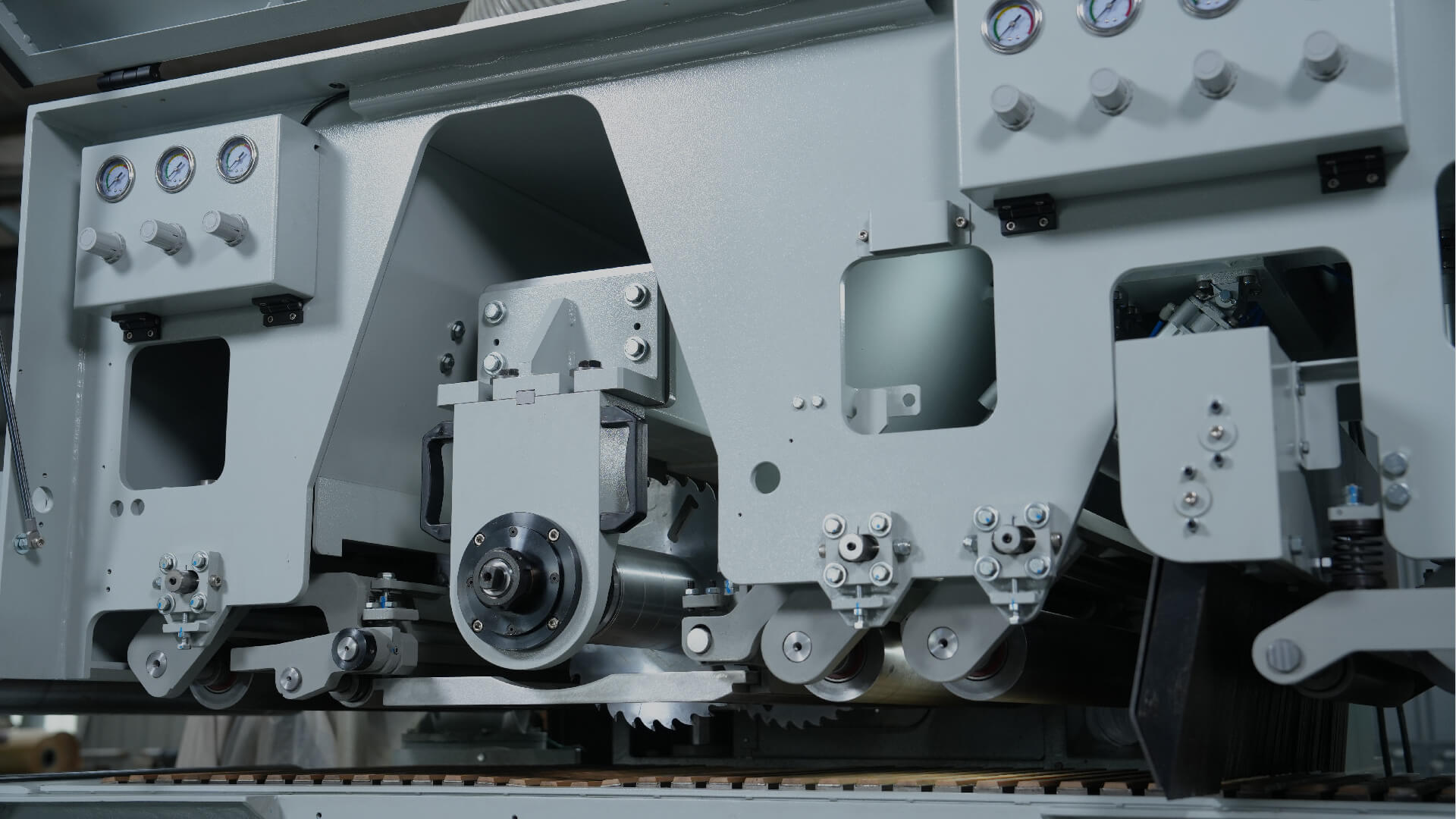 Close-up of Kuang Yung Machinery's industrial woodworking equipment showcasing CNC Cut-Off Saws and Multiple Rip Saws, emphasizing precision engineering and advanced technology.