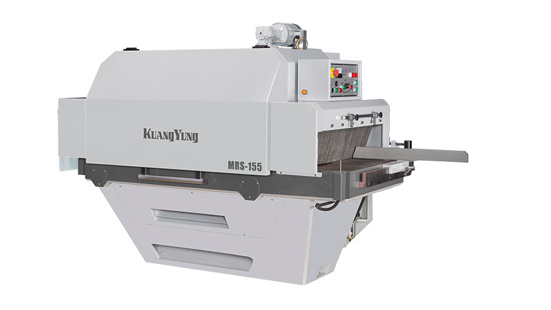 A conveyor system with multiple wooden planks being transported in a woodworking facility, featuring an industrial rip saw for processing the wood.