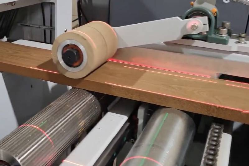 High-precision laser-guided ripping saw in action, ensuring accurate wood cutting and optimized material usage for modern woodworking production.